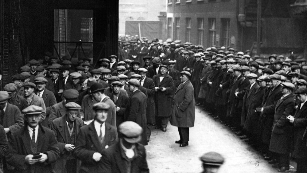 Labourers queue for work at the London docks in 1931. Photograph: Fox Photos/Getty Images